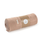 Rolled-up beige blanket with a label on a white background