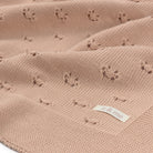 Pink textured fabric with a label on a white background