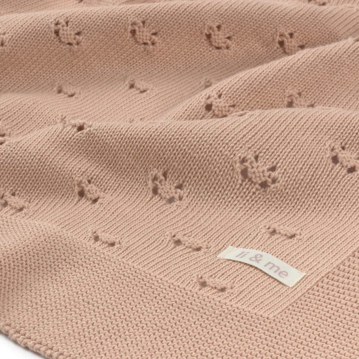 Pink textured fabric with a label on a white background