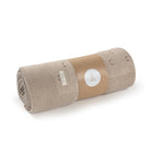 Rolled-up beige blanket with a brown paper wrap and white label on a white background