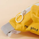 Yellow pet harness with 'My good' text on a beige background