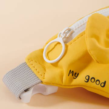 Yellow pet harness with 'My good' text on a beige background
