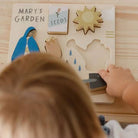 Children's educational puzzle with 'Mary's Garden' theme on a wooden surface.