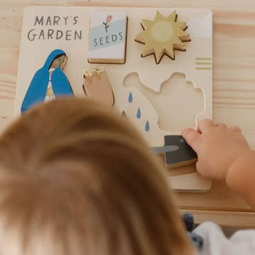 Children's educational puzzle with 'Mary's Garden' theme on a wooden surface.