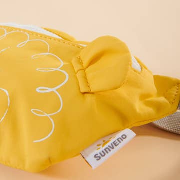Yellow pet muzzle with white embroidery on a beige background, featuring the brand 'Sunveno'.