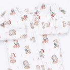 White baby footed sleeper with an all-over print of teddy bears wearing Santa hats and scarves, arranged in a flat-lay pattern.