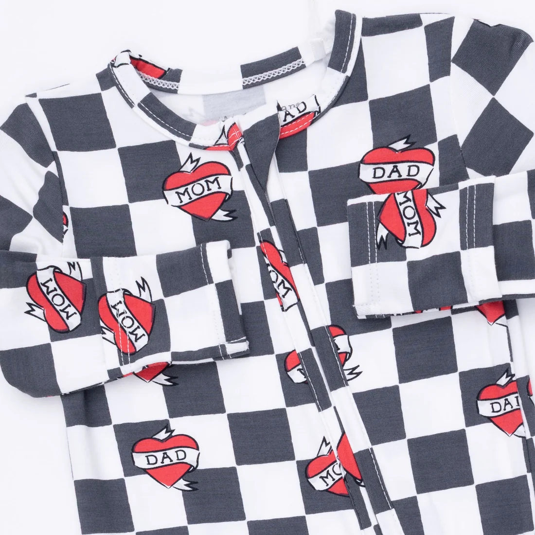 A long-sleeve baby romper featuring a black and white checkerboard pattern with red and white heart graphics that read 'DAD MOM'.