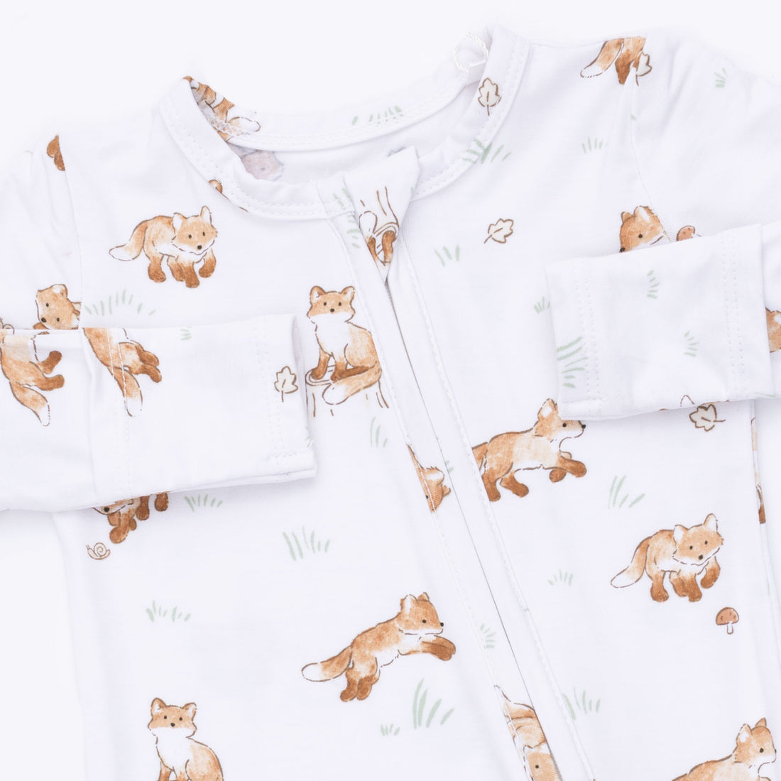 White long-sleeve baby sleep sack with an all-over print of brown foxes and small green grass accents, featuring a front zipper.