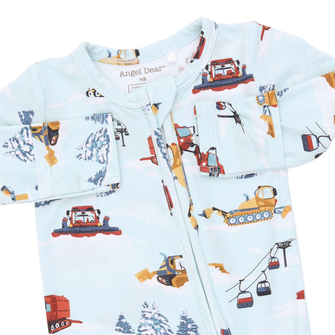 A baby long-sleeve zip-up sleeper by Angel Dear, featuring a light blue background with a playful print of construction vehicles, snowmobiles, and gondolas in winter scenes.