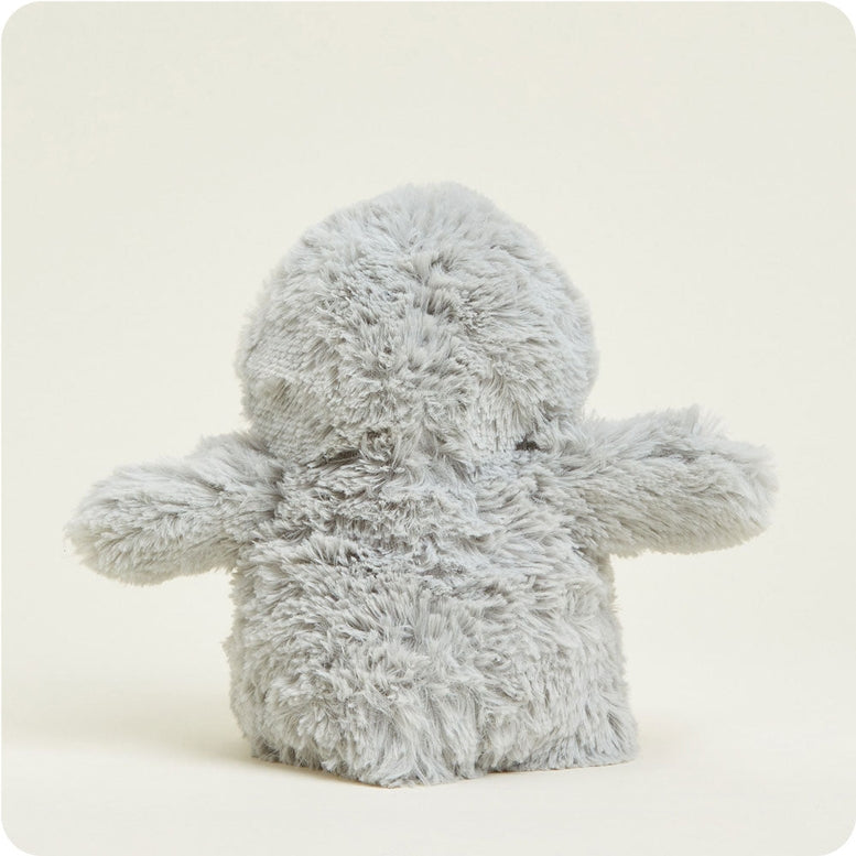 Rear view of the Gray Penguin by Warmies plush toy showing its soft gray textured body and outspread flippers against a light background.