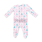 A baby long-sleeve footed sleeper with a white background, featuring a repeating pattern of pink bows and teal and pink Christmas trees, finished with a ruffled elastic waistband.