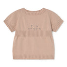 Beige knit top with floral embroidery on a white background