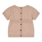 Beige knitted cardigan with buttons on a white background