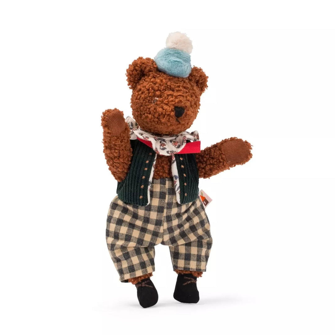 Stuffed teddy bear wearing a blue hat, plaid pants, and a patterned scarf on a white background