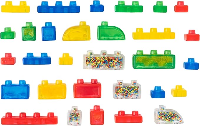 A collection of 30 colorful, translucent squishy building blocks from the Jelly Blox Stash 'n' Stack set, arranged neatly against a white background in various shapes, sizes, and textures, including special sensory pieces filled with colorful beads.