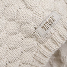 Close-up of a knit fabric with a visible brand label.