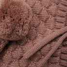 Close-up of a brown knitted blanket with a textured pattern