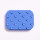 Blue rectangular silicone mat with raised circular nodes on a white background