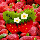 Strawberry-shaped basket with flowers surrounded by real strawberries