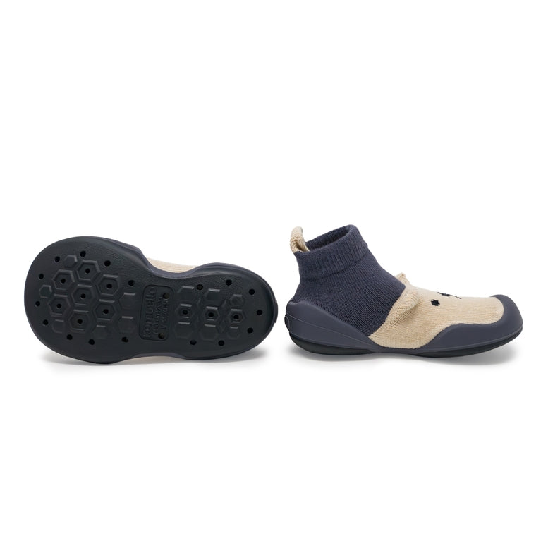 Navy and beige sock-style shoes on a white background