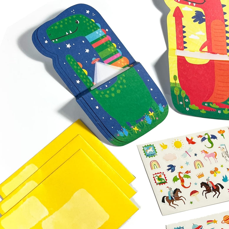 Colorful children's educational toys including a dinosaur-themed book and card set on a white background.