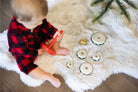 Child playing with toys on a fluffy white rug