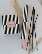 Incense sticks with packaging on a marble surface