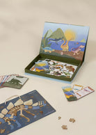 Children's educational puzzle set with dinosaur-themed cards and box on a beige background