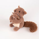 A brown plush squirrel toy holding a smaller matching squirrel, photographed on a clean white studio background.
