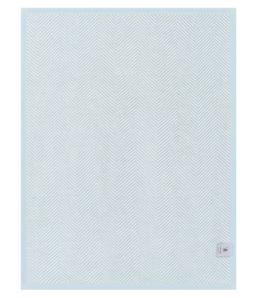Light blue textured blanket with a subtle pattern on a white background