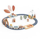 Wooden toy train set with tracks, trees, and animals on a white background