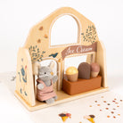 Wooden toy ice cream stand with a mouse character and ice cream cones on a white background