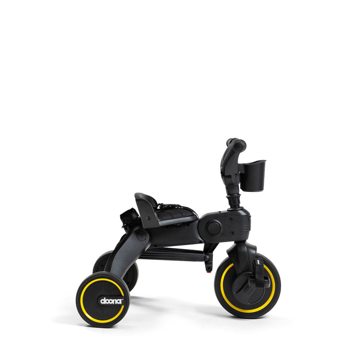 Black and yellow children's tricycle on a white background