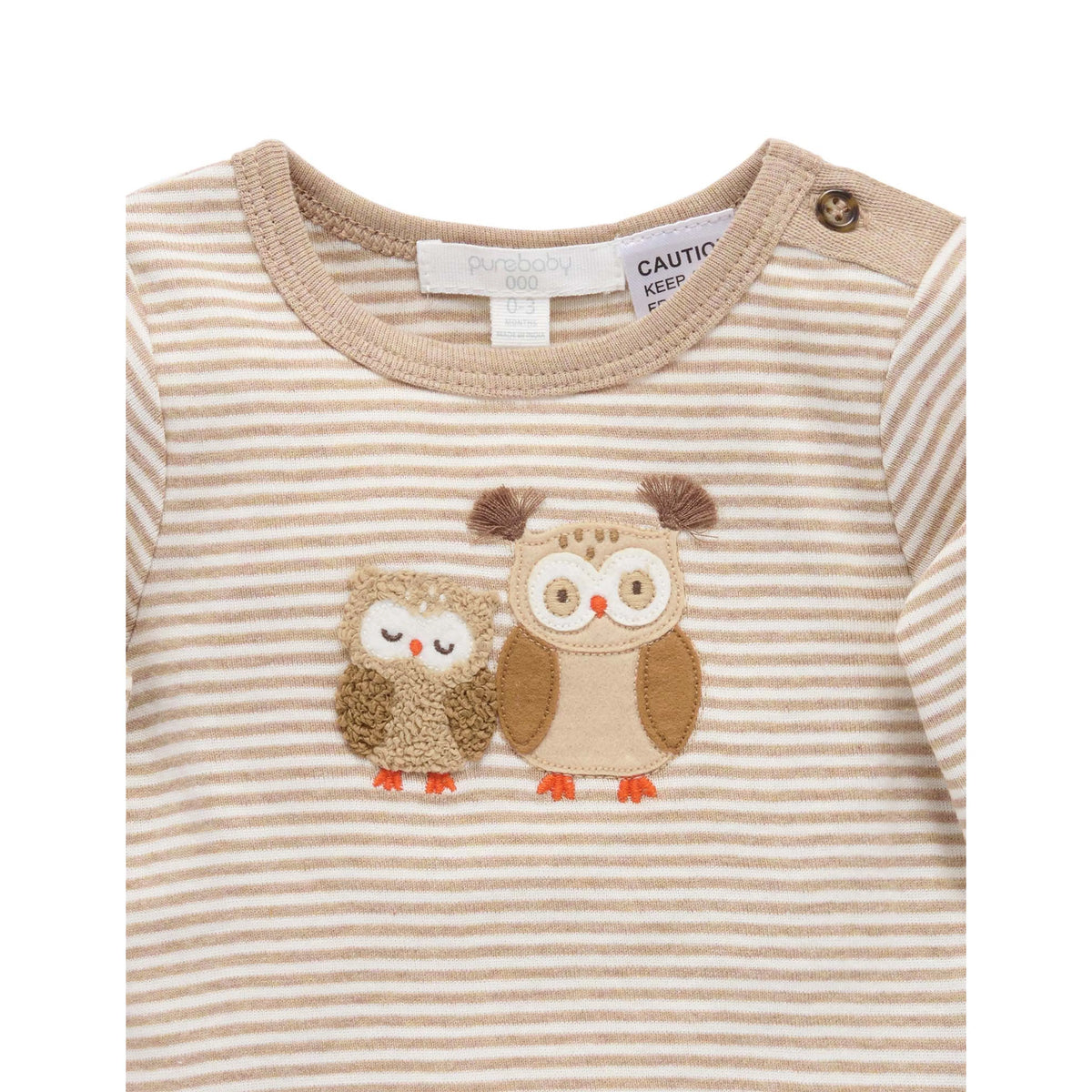 A close-up of a baby long-sleeve top with beige and white horizontal stripes, featuring two embroidered owls on the chest and a button on the shoulder.
