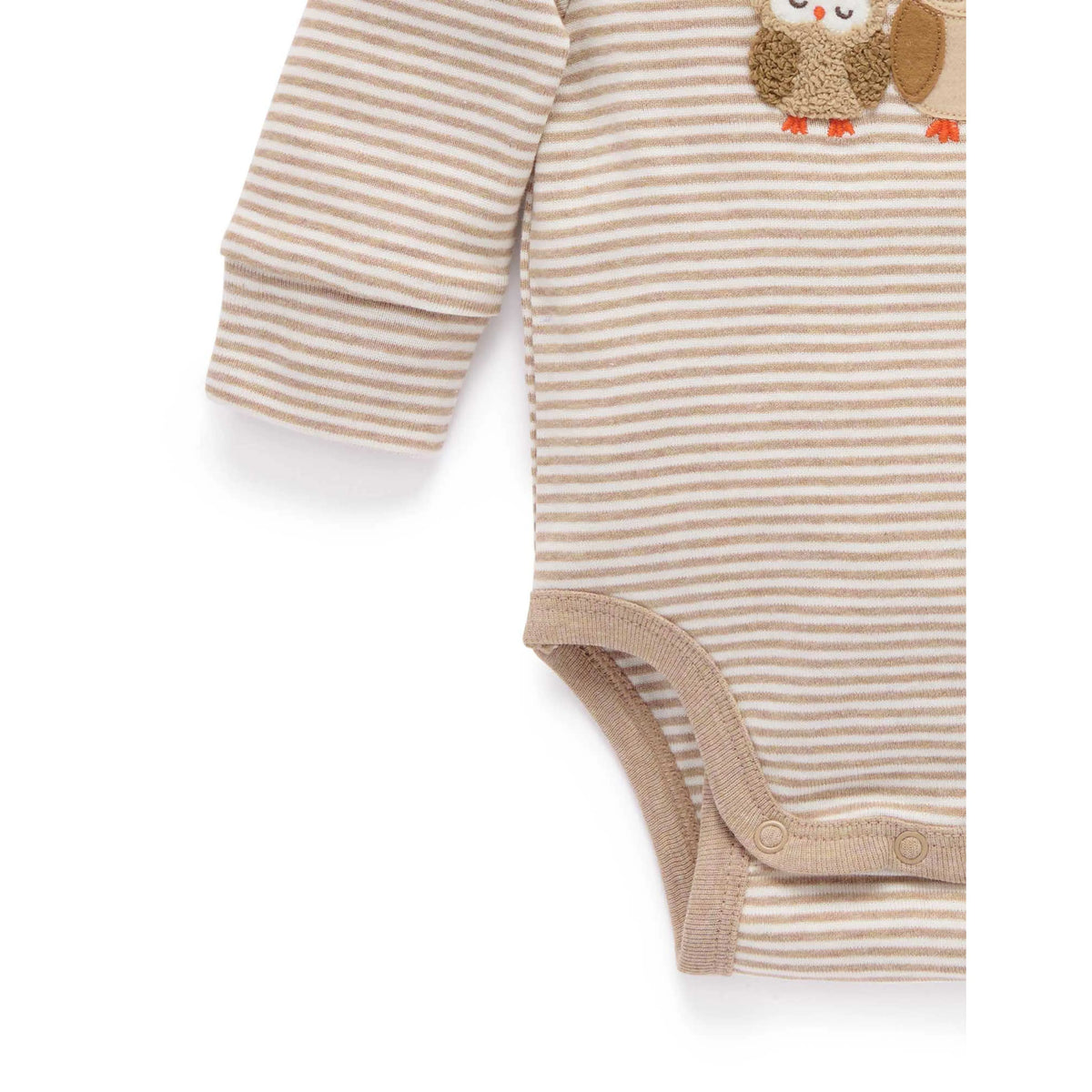 Close-up of a baby bodysuit with beige and white horizontal stripes, featuring a brown and beige owl applique on the chest and a snap closure at the crotch.