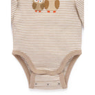 A long-sleeve baby bodysuit with thin beige and white horizontal stripes, featuring an embroidered owl design on the chest and snap closures at the crotch and shoulder.