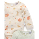Two baby long-sleeve bodysuits from The Peony Child, one in cream with a woodland animal print (foxes, rabbits, owls, mushrooms) and one in pale sage green, shown on a white background.