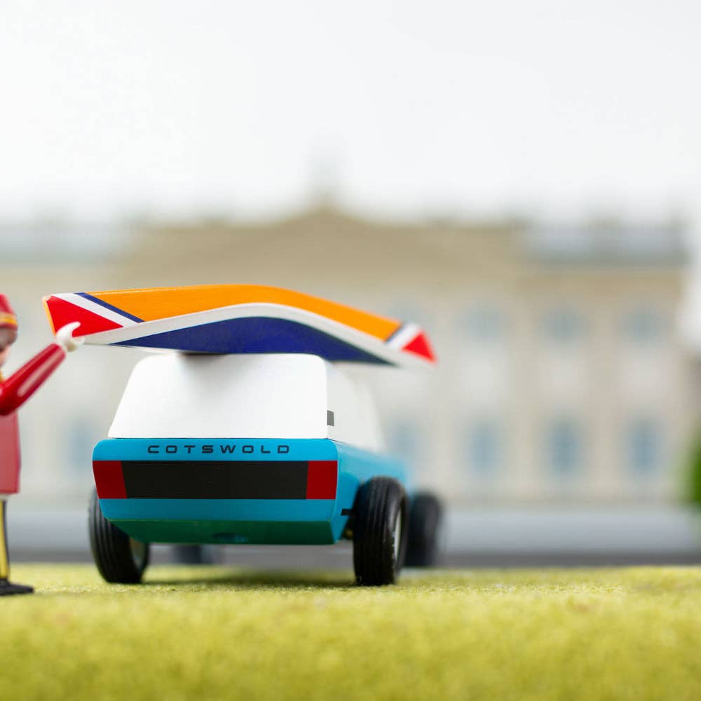 Model car with a British flag on a grassy field with a blurred background