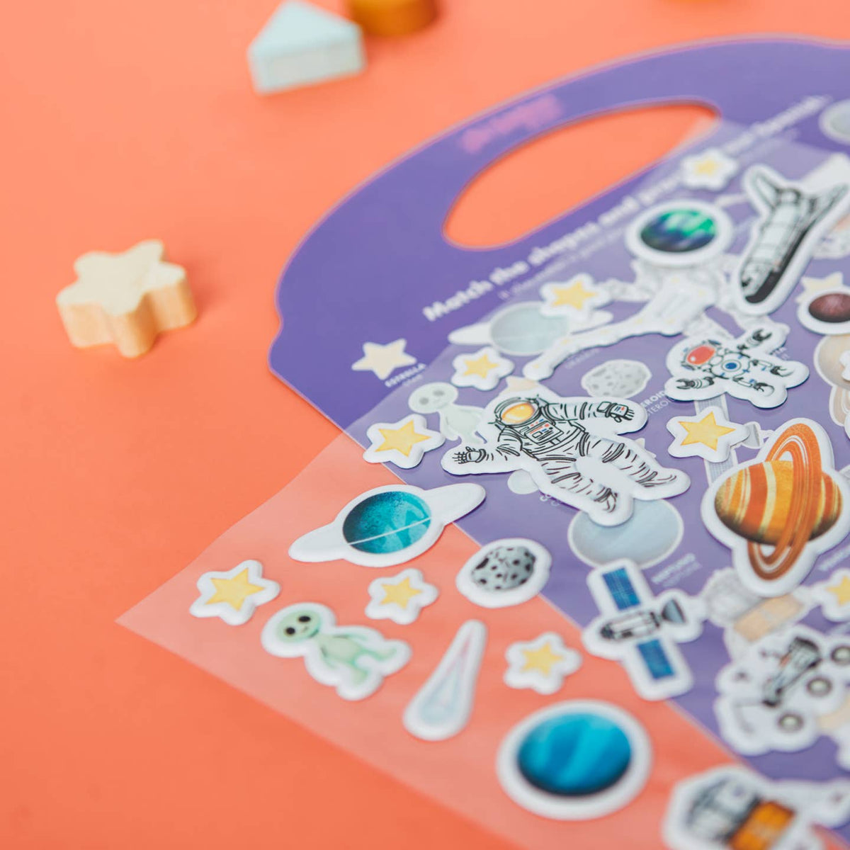 Children's sticker sheet with space-themed stickers on a colorful background