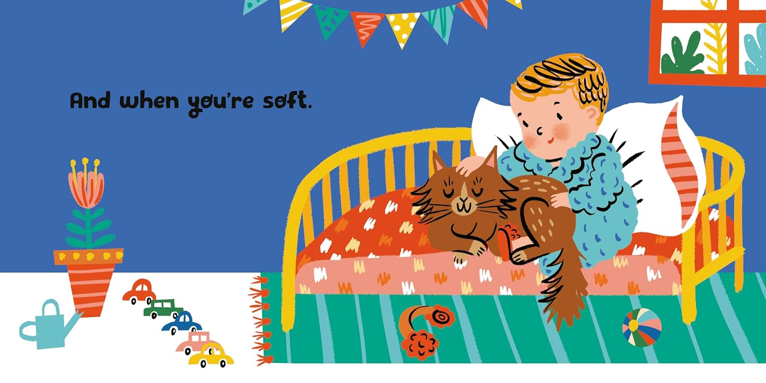 Illustration of a child reading to a cat in bed with toys on the floor.
