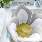 Gray sink bath pad with water flowing into it, placed over a sink.