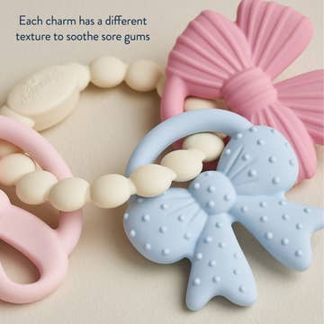 Teething toys with different textures on a beige background