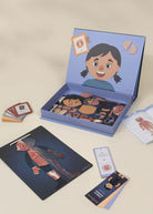Educational kit with body part cards and a book on a beige background
