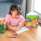 Child coloring with a 'Wild Animals' book on a table