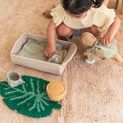 Child playing with toys on a beige carpet
