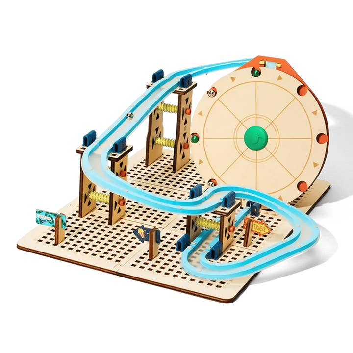 Wooden marble run toy with tracks and obstacles on a white background