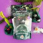 A packaged toy set called Dark Forest Mini KidDough Play Pack by Everyday Toys, shown standing upright on a bright purple background with decorative forest-themed props around it.