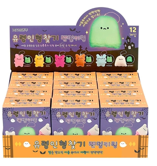 A retail display box filled with small blind-box packages for a cute ghost-shaped ring light toy. The display has Halloween-themed graphics, including bats, ghosts, and a large green ghost illustration at the top.