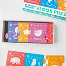 Children's Spanish alphabet floor puzzle with colorful boxes and animal illustrations.
