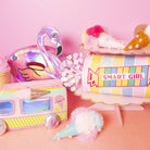 Colorful stationery items including a flamingo-shaped pouch, a pencil case, and a cup with 'SMART GIRL' text on a pink background.